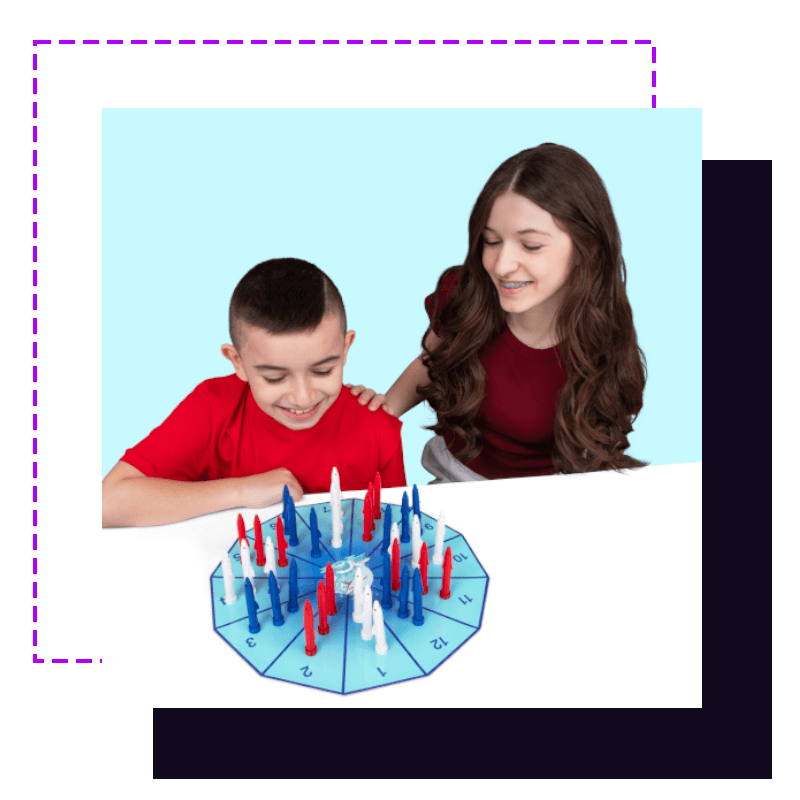 A boy and girl smiling as they play the Shark Math Power game board